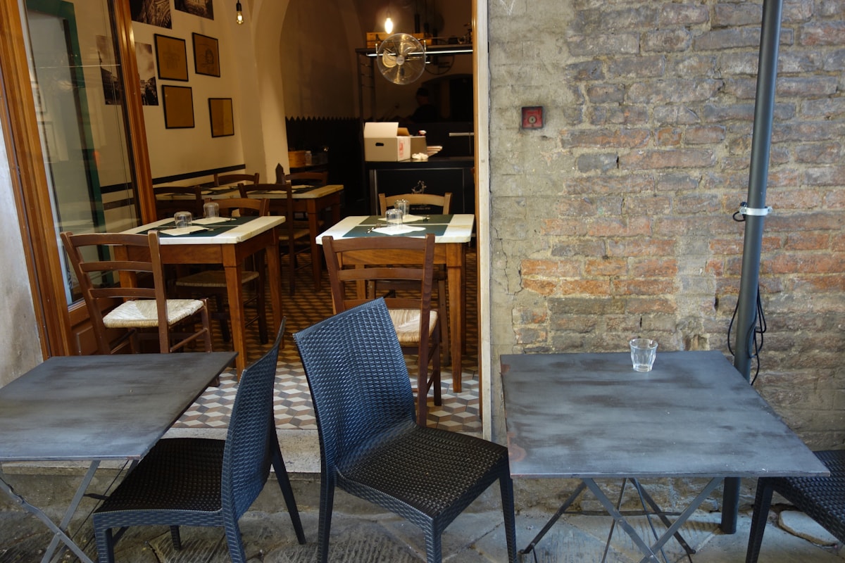 Tables laid for outdoor dining on a restaurant terrace